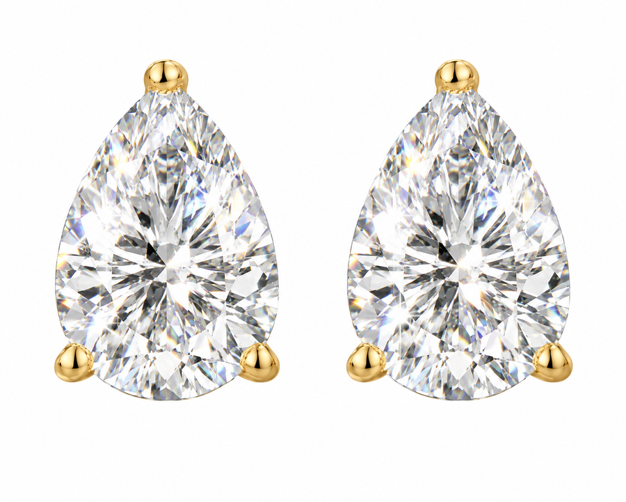 A pair of pear-cut diamond stud earrings in yellow gold settings, shown on a plain white background.